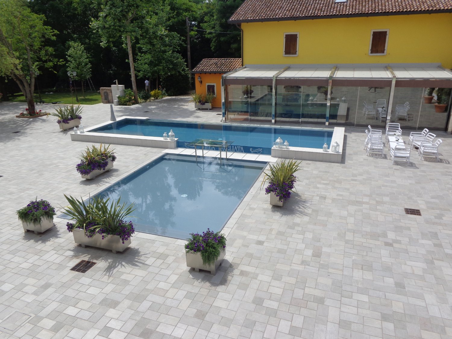 Panoramica piscina a sfioro con ampia zona relax realizzata completamente su misura